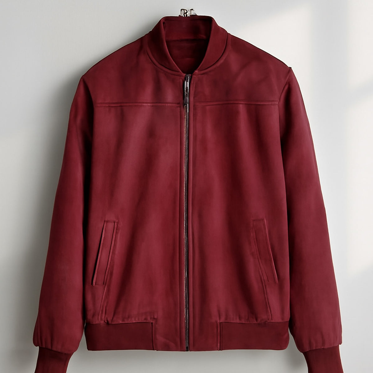 Bomber jacket in deep burgundy red with matte finish and dark gray zipper.