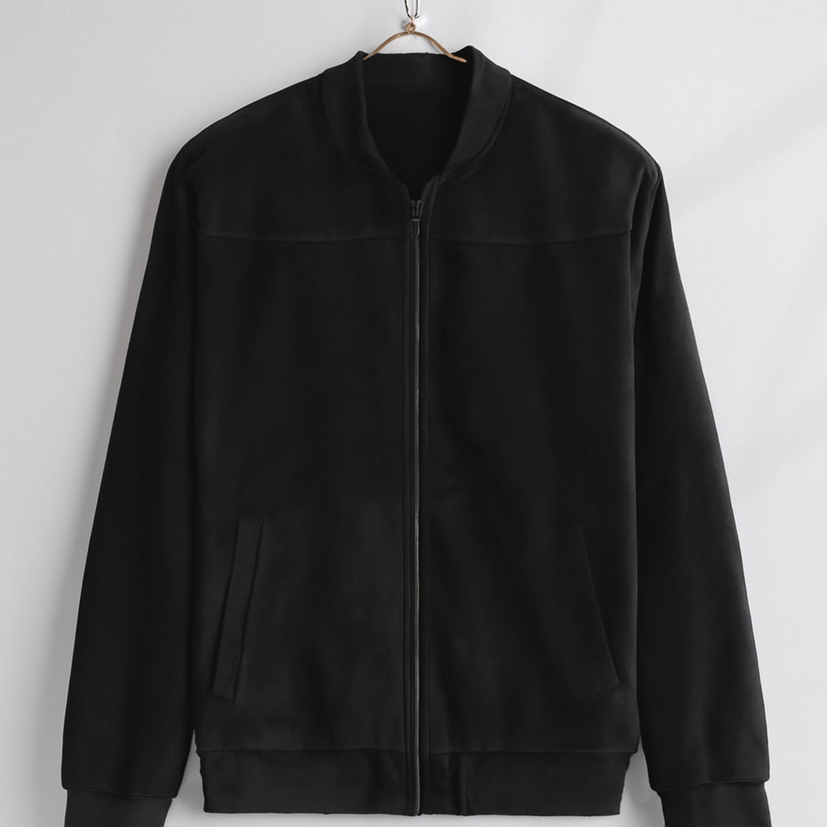 Bomber jacket in black with matte finish and black zipper.