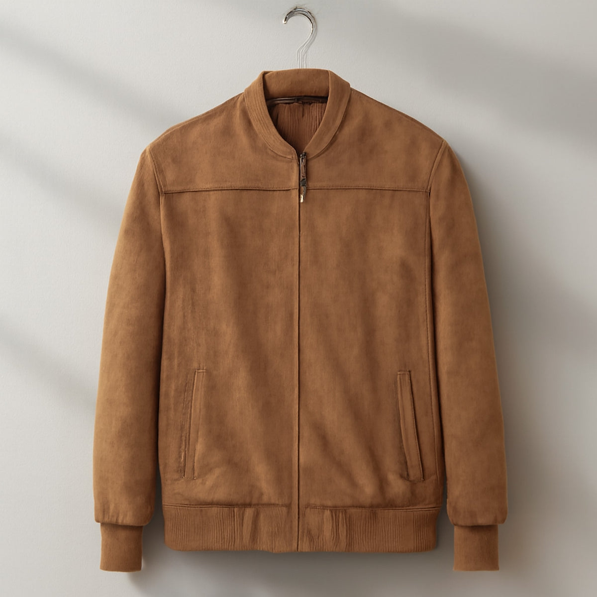 Bomber jacket in warm medium brown with matte finish and silver zipper.