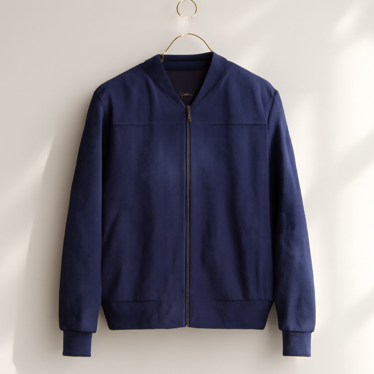 Bomber jacket in medium navy blue with soft matte look and gunmetal zipper.
