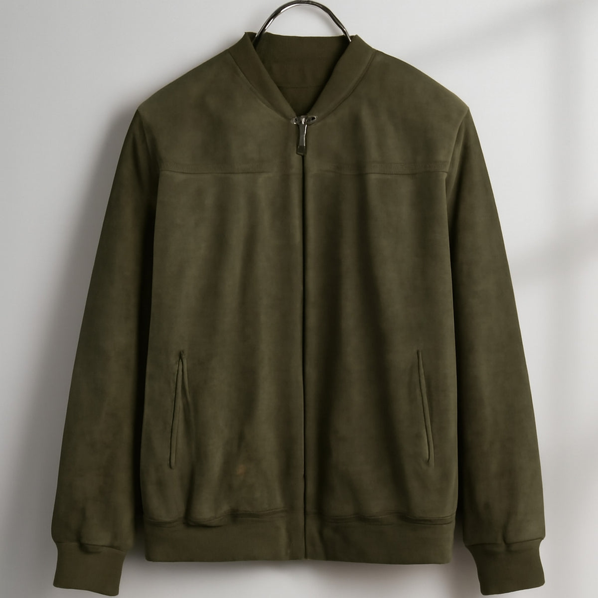 Bomber jacket in olive green with soft matte finish and dark gray zipper.